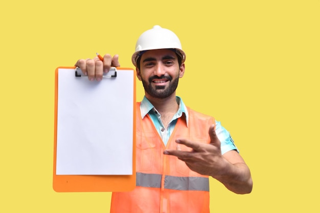 construction worker smiling and showing clipboard indian pakistani model