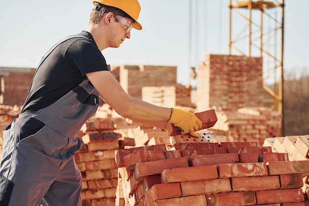 Construction worker in uniform and safety equipment have job on building