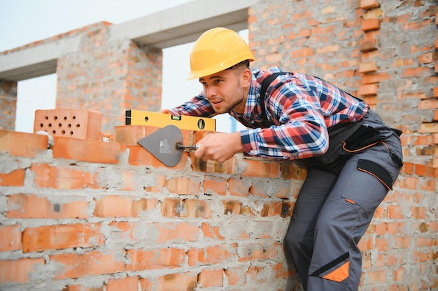 Construction worker in uniform and safety equipment have job on building