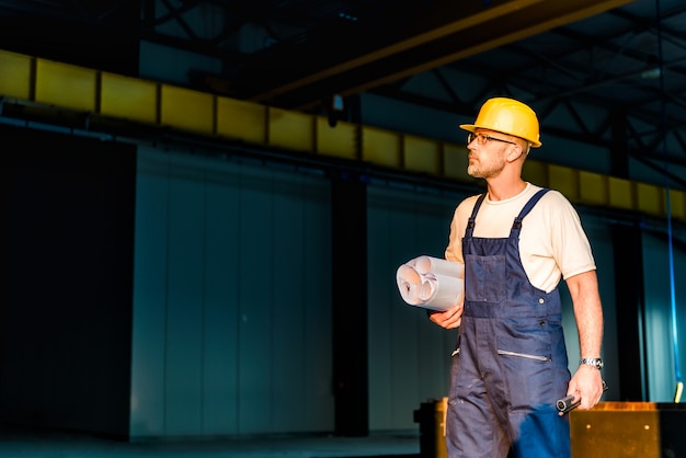 Construction worker with blue prints