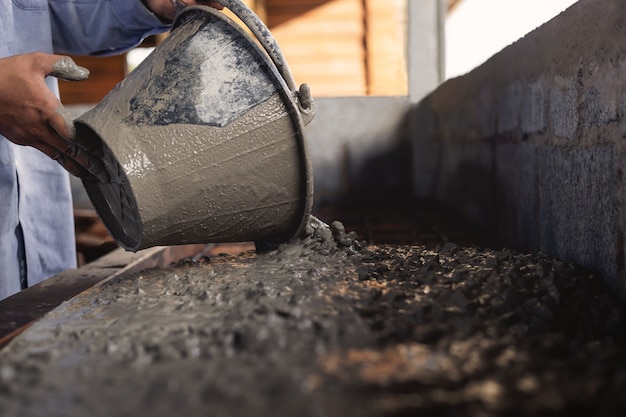 Construction workers are doing cement in home renovation work.