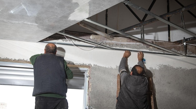 Construction workers assembling a suspended ceiling