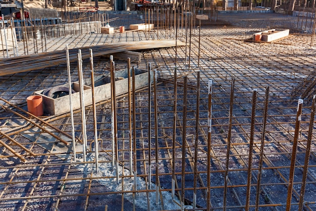 Construction workers fabricating steel reinforcement bar at the construction site.The reinforcement bar was ties together using tiny wire.