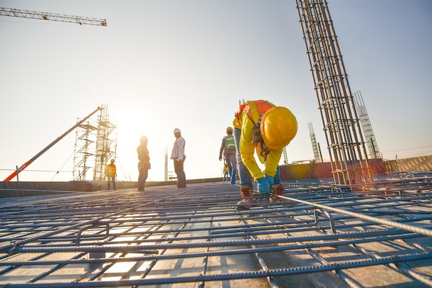 Construction workers fabricating steel reinforcement bar at the construction site