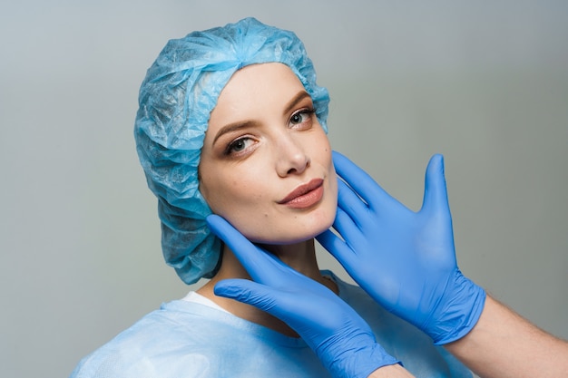 Consultation with plastic surgeon on white surface