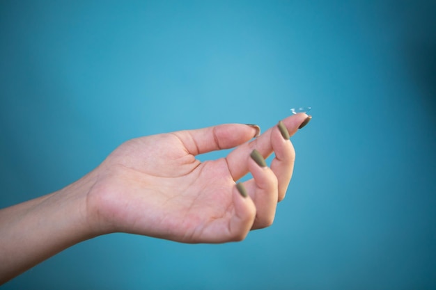 Contact Eye Lenses. Woman Hands Holding Contact Eye Lens.