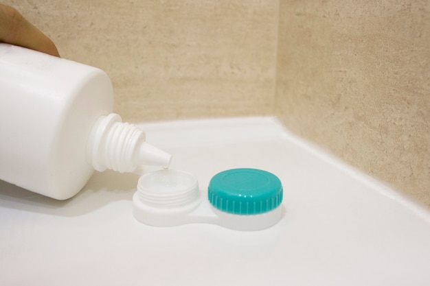 Contact lens and bucket container with liquid