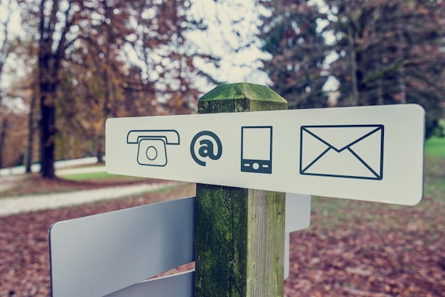 Contact signboard in an autumn park