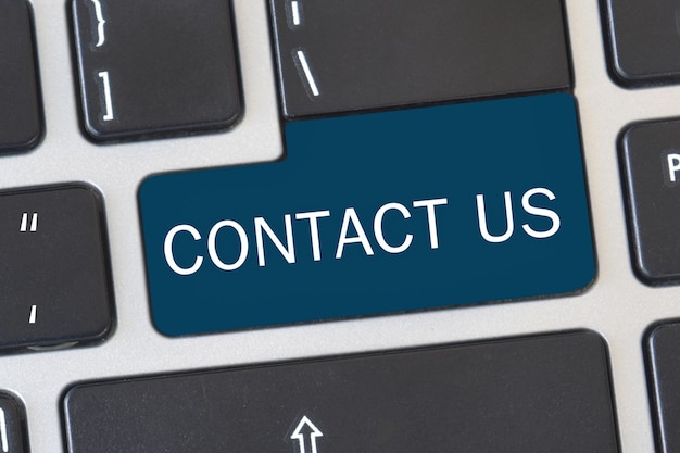 Photo contact us button on keyboard concept of internet online contact through website