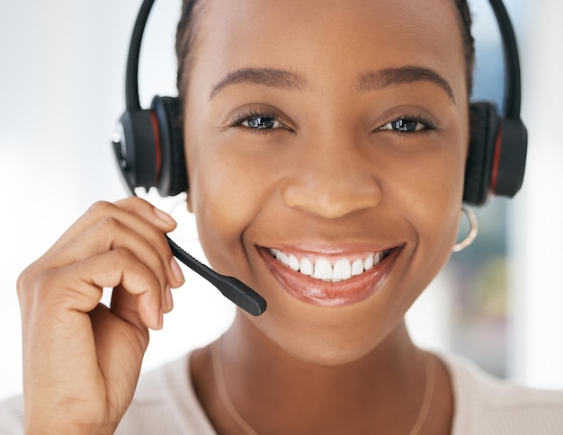 Contact us portrait and black woman in customer support in call center with a microphone for communication Smile telemarketing or happy insurance sales agent talking speaking and helping clients