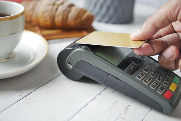 Contactless payment concept with young man paying with credit card