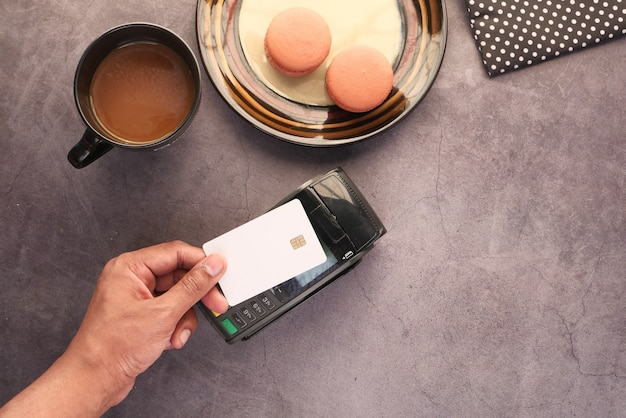 Contactless payment concept with young man paying with credit card