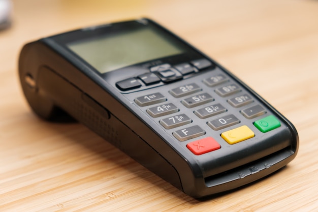 Contactless terminal on the wooden desk