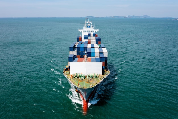 Container cargo ship carrying commercial container in import export business services