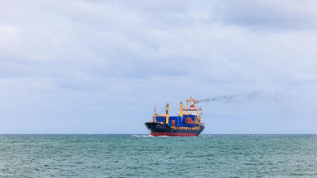 Container cargo ship sailing in green sea to transport of goods import export internationally