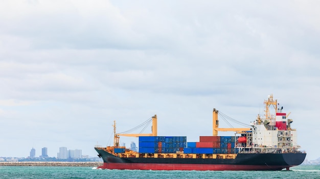 Container cargo ship sailing in green sea to transport of goods import export internationally