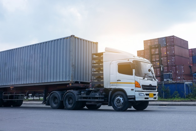 Container cargo truck in ship port Logistics. Transportation industry in port business concept.