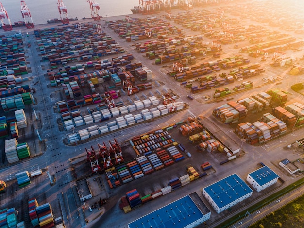 Container ship in export and import business and logistics Shipping cargo to harbor by crane Water transport International Aerial view