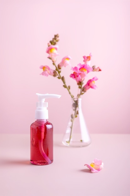 Container with organic natural cosmetics and flowers