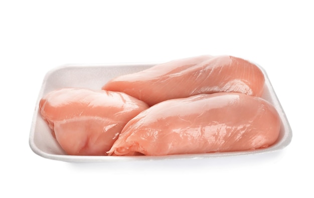 Container with raw chicken fillet on white background