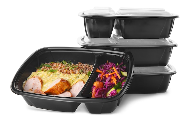 Containers with healthy food on white