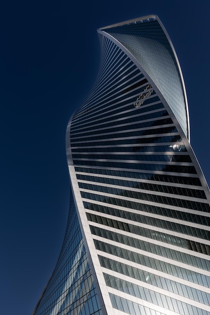 Contemporary architecture in Moscow City with bottom up view of Evolution Tower skyscraper