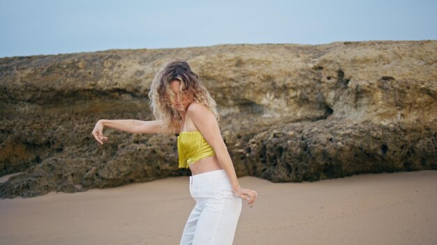 Contemporary dancer performing improvisation on sand summer day woman dancing