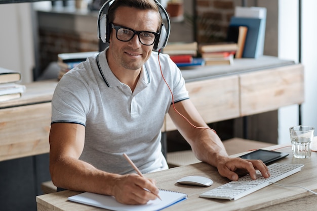 Contemporary office. Bright emotional nice guy enjoying a productive day