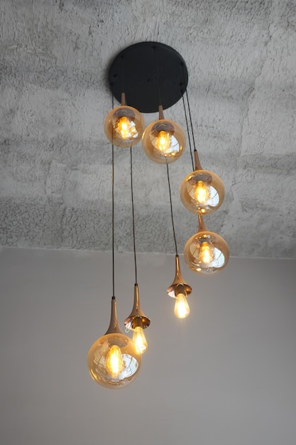 A contemporary pendant light features gold glass globes adding chic style to your living space