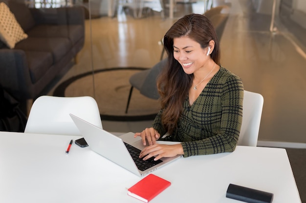 Content Asian worker with laptop in office