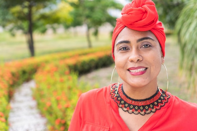 Content black lady looking at camera on park