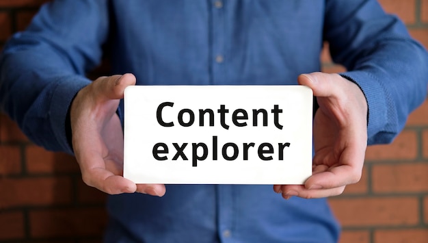 Photo content explorer - seo concept in the hands of a young man in a blue shirt