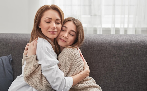 Content mother and daughter hugging at home