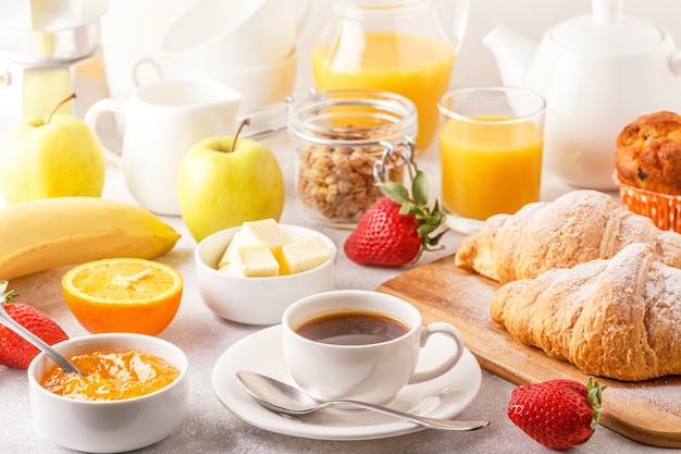 Continental breakfast with fresh croissants, orange juice and coffee, selective focuse.