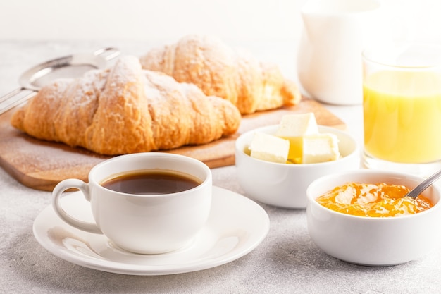 Continental breakfast with fresh croissants, orange juice and coffee, selective focuse.