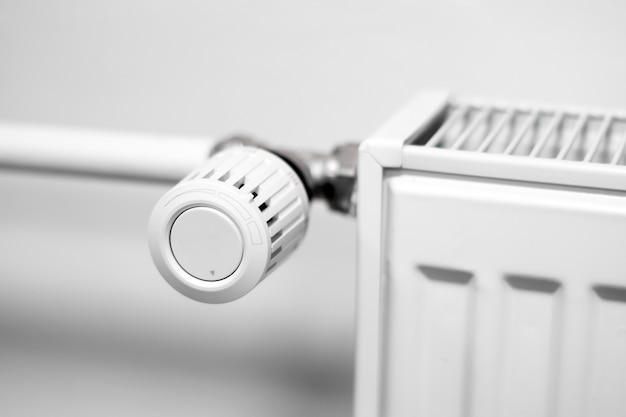 Photo control valve on a central heating radiator in a room