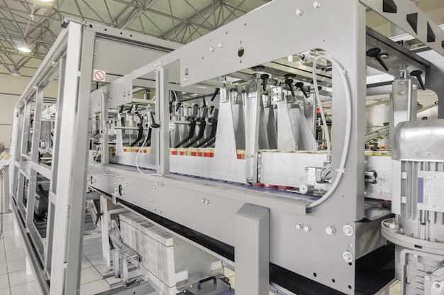 Conveyor belt in motion at production and bottling of drinks in tin cans