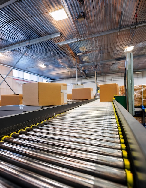 a conveyor belt in a warehouse with packages moving on it