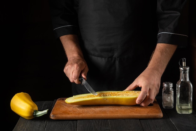 The cook cuts ripe yellow marrow with a knife. Fried zucchini is a great diet for breakfast or lunch. Work environment on the kitchen table of the restaurant. Free advertising space.