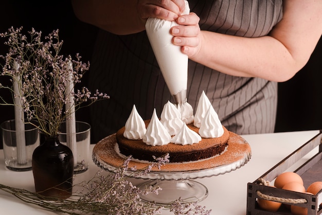 Cook decorating cake with icing