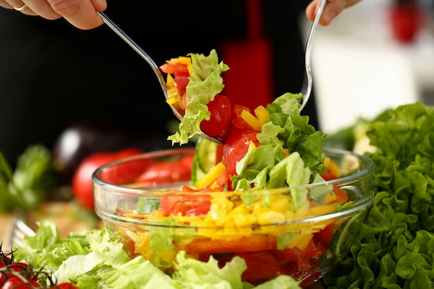 Cook holds fork in hand and mixes