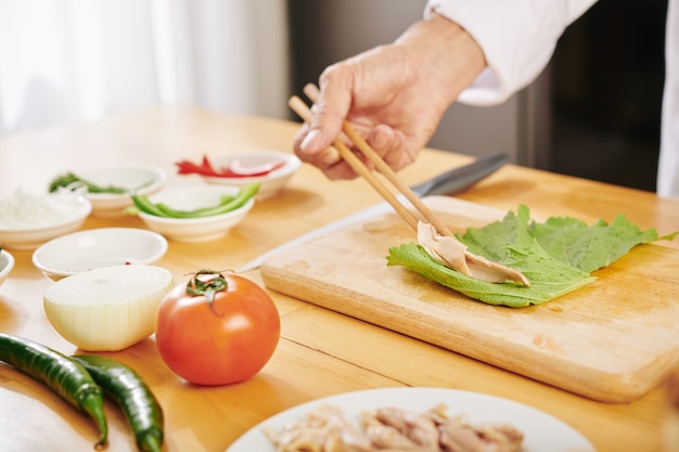 Cook making chiken roll