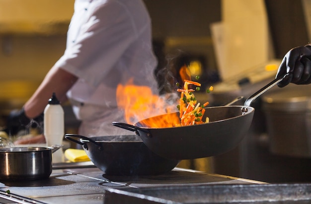 Cook making dinner in the kitchen of high-end restaurant.