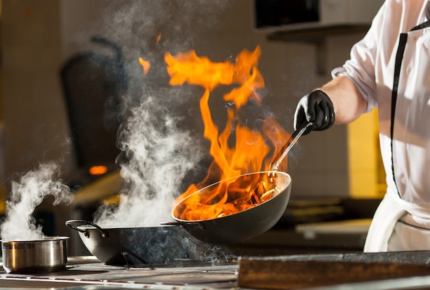 Cook making dinner in the kitchen of high-end restaurant.