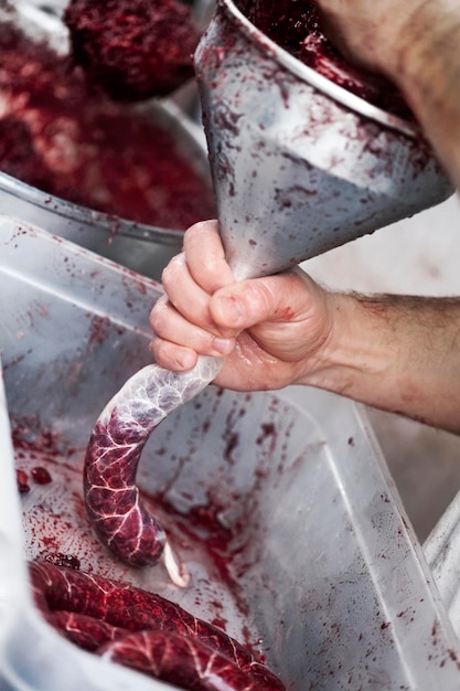 Cook making sausage in a deli shop