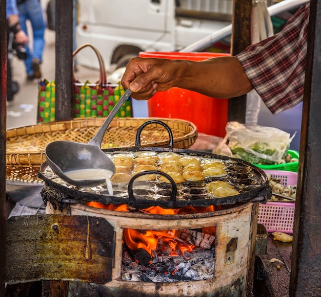 Cook prepares street food in Myanmar