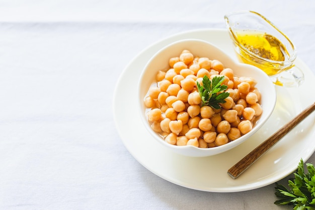 Cooked chickpeas in white bowl Ingredient for Tasty vegetarian food Boiled chickpeas selective focus