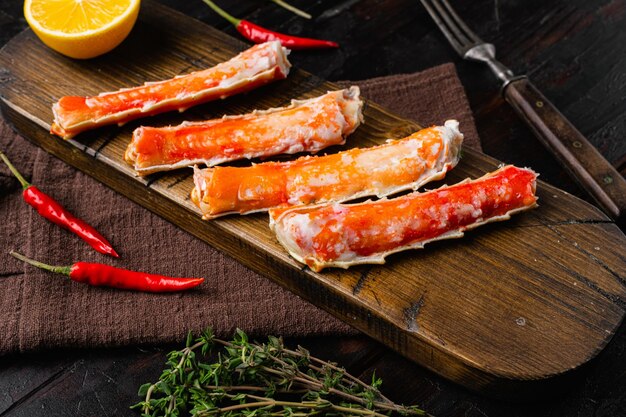 Cooked crab legs set, on old dark  wooden table background