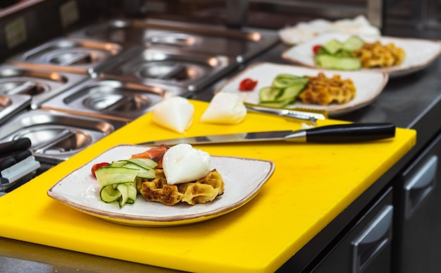 cooked dish in a restaurant in the kitchen on a yellow cutting board