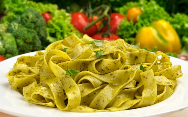 Cooked italian fettuccine pasta with pesto sauce